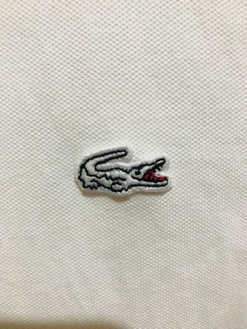 Lacoste White Polo Shirt Size 40 Devanlay (Category: Luxury Apparel) located in Rizal. Submitted by drthrifttwo (Listing ID 1469572057, Image 2). Description: - 100% Authentic Lacoste white polo shirt - Size 40 (Devanlay manufacturing) - Classic embroidered green crocodile logo on the chest - Branded mother-of-pearl buttons - Short sleeves with ribbed collar - Clean white fabric, ready to wear - Exact measurements listed on the inner tag.