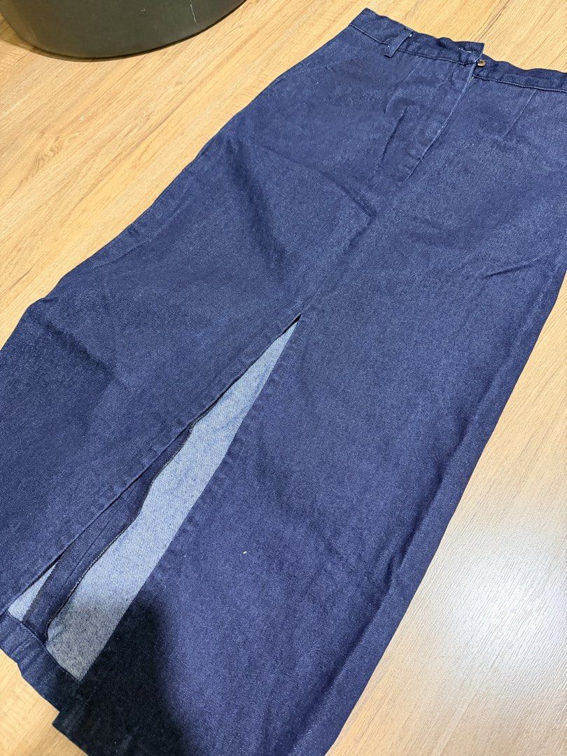 LAYA Studio Denim midi skirt Size M (Category: Skirts) located in Makati City. Submitted by toneeann (Listing ID 1469449370, Image 3). Description: - Brand: LAYA - Style: Denim midi skirt in a classic dark blue wash - Size: Medium - Fit: Straight silhouette hitting below the knee with a front slit for easy movement - Details: Structured waistband, belt loops, front zip fly, and button closure - Condition: Clean finish inside and out, perfect for 