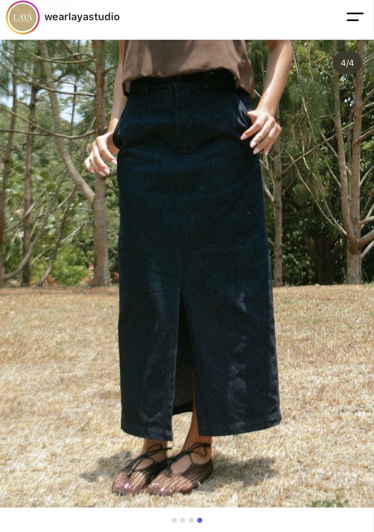 LAYA Studio Denim midi skirt Size M (Category: Skirts) located in Makati City. Submitted by toneeann (Listing ID 1469449370, Image 2). Description: - Brand: LAYA - Style: Denim midi skirt in a classic dark blue wash - Size: Medium - Fit: Straight silhouette hitting below the knee with a front slit for easy movement - Details: Structured waistband, belt loops, front zip fly, and button closure - Condition: Clean finish inside and out, perfect for 