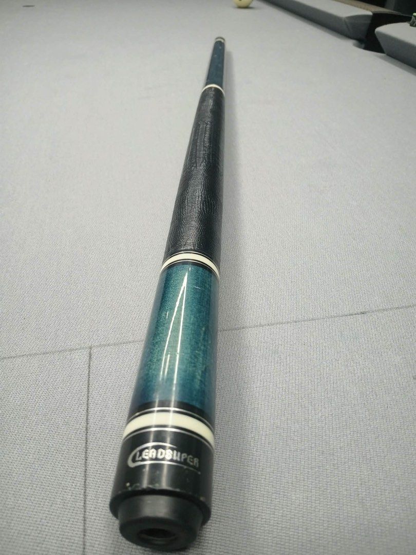 Leadsuper Pool Cue Blue Wood Grain Finish (Category: Billiards and Bowling) located in Mandaluyong City. Submitted by rga555 (Listing ID 1469500691, Image 2). Description: - Brand: Leadsuper - Design: Striking blue wood grain forearm with matching blue sleeve and white accent rings - Grip: Black faux-lizard wrap for a solid, comfortable hold - Joint: Metallic pin joint - Details: Standard two-piece butt section with silver Leadsuper branding plat