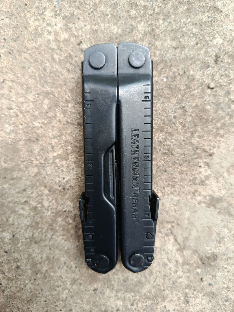 Leatherman Rebar Black Multi-Tool (Category: Construction Tools & Equipment) located in Valenzuela. Submitted by wildstar.015060 (Listing ID 1469460767, Image 1). Description: Leatherman Rebar multi-tool in black finish. Includes needlenose pliers, regular pliers, wire cutters, knife blades, wood saw, file, screwdrivers, and bottle opener. Built entirely in stainless steel. Heavy-duty construction with integrated rulers on the handles. All tools 