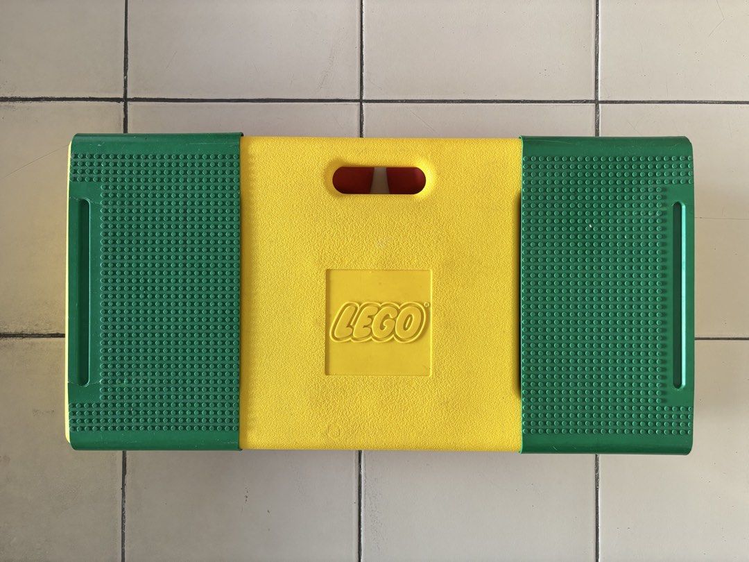 LEGO Play Table with Storage Compartments and Bricks (Category: Lego & Building Sets) located in Quezon City. Submitted by msuyo (Listing ID 1469571062, Image 1). Description: - Vibrant yellow, green, and red LEGO play table with green baseplates on top - Built-in storage compartments on both ends to keep things organized - Comes with a mix of standard bricks and larger toddler blocks - Foldable red legs underneath for easy storage and portabilit