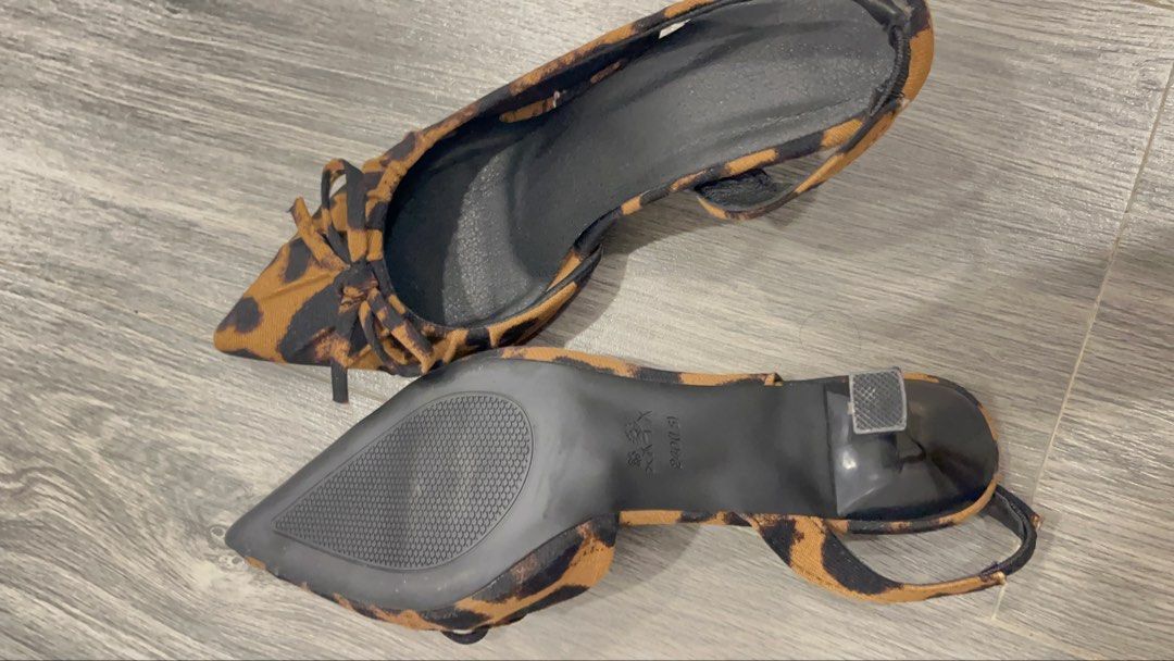 Leopard Print Slingback Kitten Heels with Bow Size 37 (Category: Heels) located in Quezon City. Submitted by ashlymae (Listing ID 1469396544, Image 2). Description: - Style: Chic leopard print kitten heels with slingback strap and pointed toe - Detail: Cute tiny bow on top - Size: 37 (stamped on bottom) - Comfort & Safety: Medium height wearable heel with black rubber soles offering good grip - Condition: Clean overall with minimal wear on soles.