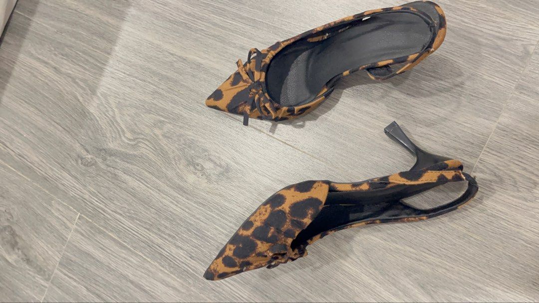 Leopard Print Slingback Kitten Heels with Bow Size 37 (Category: Heels) located in Quezon City. Submitted by ashlymae (Listing ID 1469396544, Image 3). Description: - Style: Chic leopard print kitten heels with slingback strap and pointed toe - Detail: Cute tiny bow on top - Size: 37 (stamped on bottom) - Comfort & Safety: Medium height wearable heel with black rubber soles offering good grip - Condition: Clean overall with minimal wear on soles.