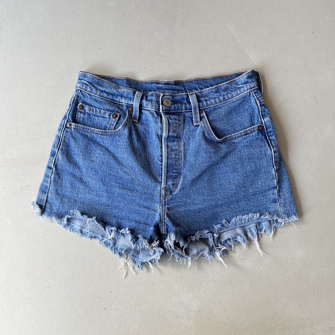 Levi's 501 Cut-off Denim Shorts (Category: Shorts) located in Mandaue City. Submitted by chinsyap_03 (Listing ID 1469468320, Image 2). Description: - Brand: Levi's 501 - Style: Denim shorts with raw frayed hems - Color: Classic medium blue wash - Details: Button fly closure, back patch pockets, iconic leather waist patch - Measurements: 28-inch waist, 11.5-inch length - Condition: Great wardrobe staple, perfect for warm weather.