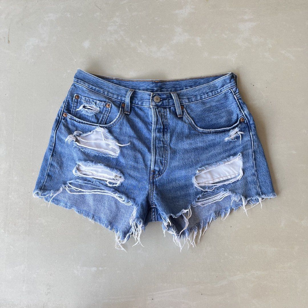 Levi's 501 Distressed Denim Shorts Size 30 (Category: Shorts) located in Mandaue City. Submitted by chinsyap_03 (Listing ID 1469467726, Image 2). Description: - Brand: Levi's 501 - Wash: Medium blue with heavy distressing and rips - Details: Button fly, branded hardware, signature leather back patch, and raw frayed hem - Measurements: Waist 30 inches, Length 12 inches - Condition: Excellent pre-loved condition - Mode of Payment: GCash or BPI - Sh