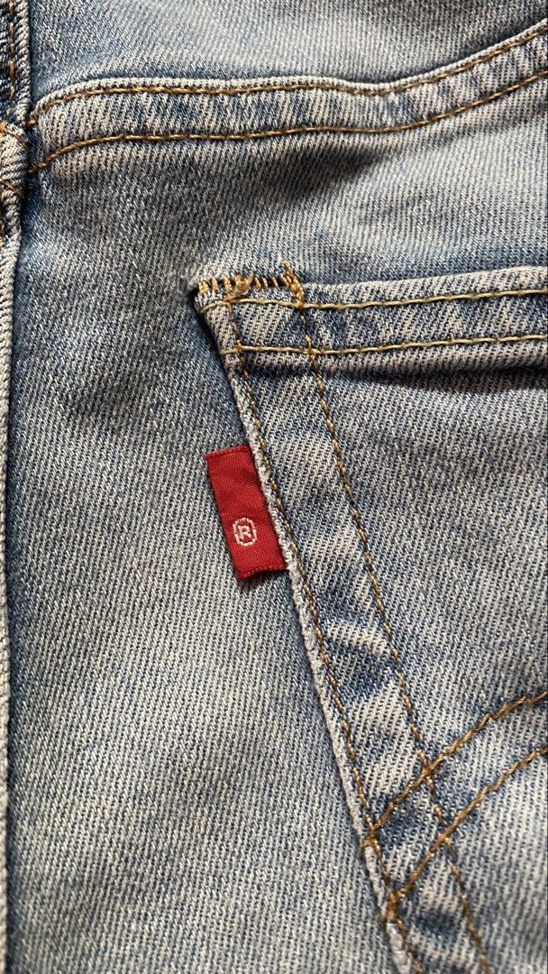 Straight Cut Jeans (Levi's) (Category: Jeans) located in Baguio. Submitted by lhynebosaing22 (Listing ID 1469417814, Image 3). Description: - Brand: Levi's - Style: Boyfriend jeans / Relaxed fit - Size: 26 (with measurement tape on waistband) - Wash: Light blue - Details: Distressed legs and knees, classic five-pocket style, button fly, branded hardware, and iconic red tab - Rise: Comfortable mid-rise - Condition: Great casual denim option.