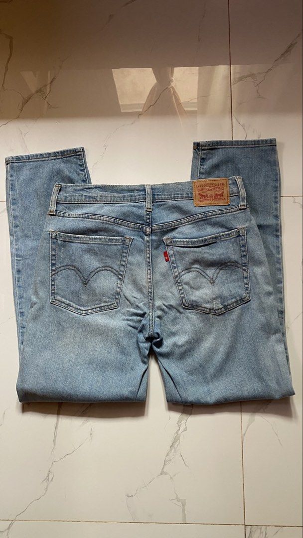 Straight Cut Jeans (Levi's) (Category: Jeans) located in Baguio. Submitted by lhynebosaing22 (Listing ID 1469417814, Image 2). Description: - Brand: Levi's - Style: Boyfriend jeans / Relaxed fit - Size: 26 (with measurement tape on waistband) - Wash: Light blue - Details: Distressed legs and knees, classic five-pocket style, button fly, branded hardware, and iconic red tab - Rise: Comfortable mid-rise - Condition: Great casual denim option.