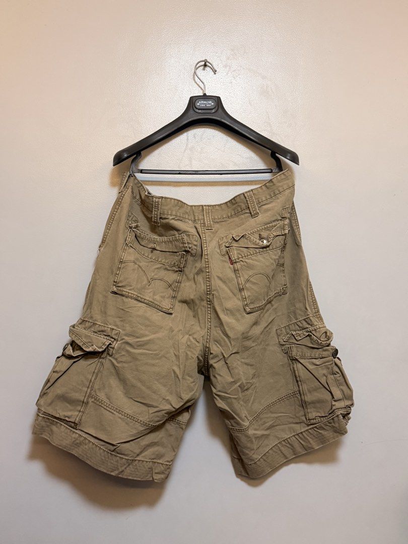 Levi's Squad Cargo Shorts W40 Khaki (Category: Shorts) located in Manila. Submitted by swiftgem.eeb06e (Listing ID 1469515498, Image 2). Description: - Brand: Levi's (Squad Cargo Shorts) - Size: W40 - Color: Khaki - Material: 100% Cotton - Features: Multiple side and back pockets, button closure, standard belt loops, branded metal button, and classic Levi's red tab - Condition/Origin: Great everyday warm weather staple, Made in China - Size: 40 -