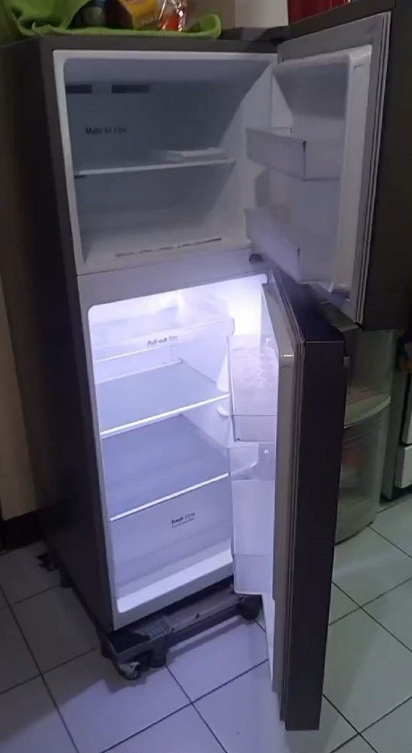 LG Smart Inverter Double Door Refrigerator (Category: Refrigerators and Freezers) located in Manila. Submitted by youngshark_6ca530 (Listing ID 1469426933, Image 2). Description: - Brand/Model: Dark grey LG double door fridge - Freezer: Top-mount with multi air flow system - Fridge Section: Includes pull-out tray and fresh zone crisper drawer - Storage: Convenient door bins on both upper and lower doors - Condition: Clean, well-maintained, and re