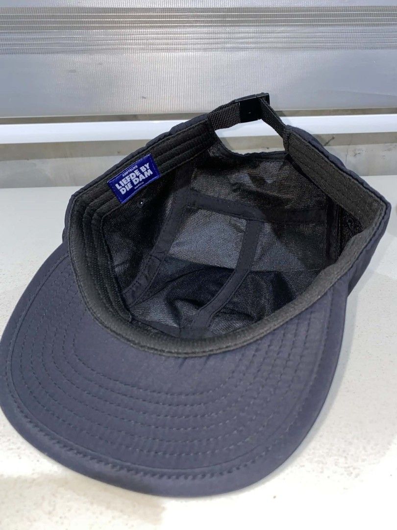 Liefde By Die Dam Black Duck 5-Panel Cap (Category: Caps & Hats) located in Baler. Submitted by mariokush193815 (Listing ID 1469452642, Image 3). Description: - Authentic Liefde By Die Dam festival merch cap in classic black - Features a charming embroidered yellow and white duck graphic on the front - Adjustable strapback closure with a metal buckle for a custom fit - Clean structured brim and lightweight fabric for all-day comfort - Finished wi