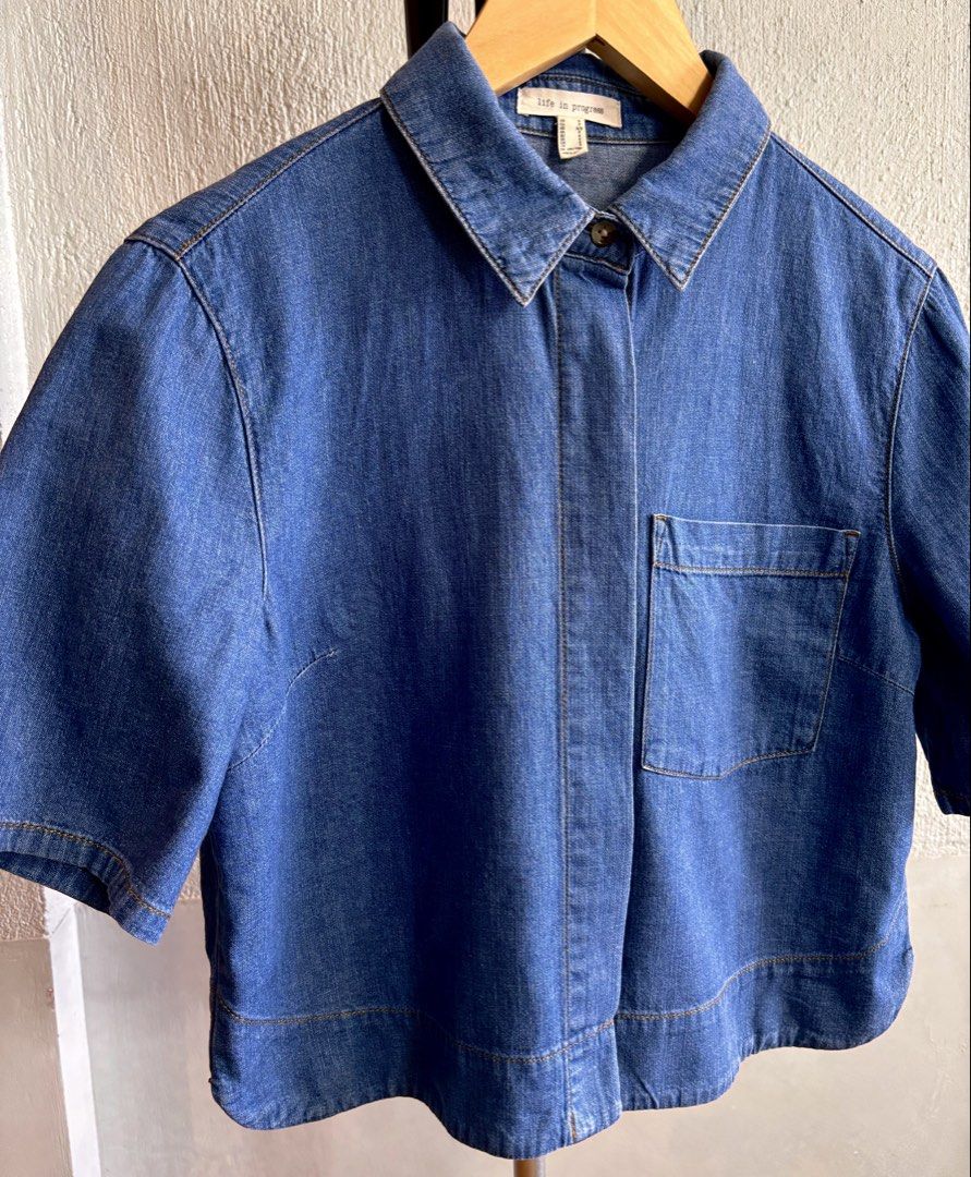 Life in Progress Denim Short Sleeve Button Up Shirt (Category: Shirts) located in Las Pinas. Submitted by tienda_ (Listing ID 1469403258, Image 1). Description: Life in Progress (H&M) Style: Blue denim short sleeve shirt Closure: Button-up with hidden placket Details: Left chest pocket, classic collar, and stylish hem stitching .