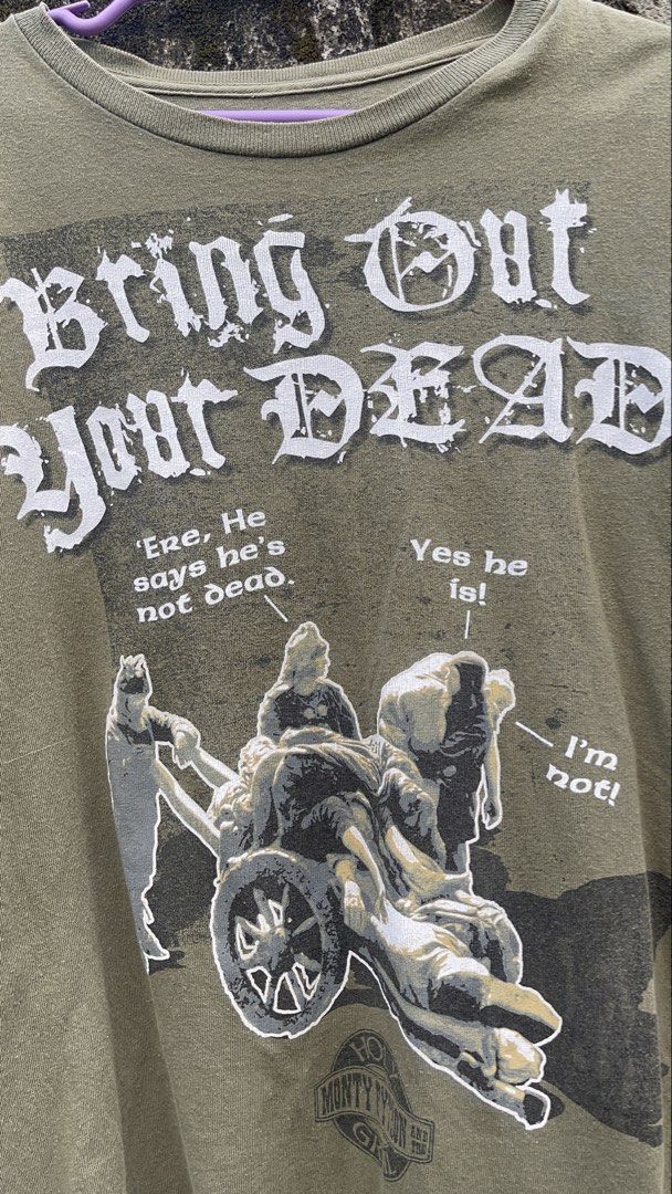 Liquid Blue Monty Python Bring Out Your Dead T-Shirt (Category: Tshirts & Polo Shirts ) located in Balanga. Submitted by death_vintage (Listing ID 1469476251, Image 2). Description: - Brand: Liquid Blue - Design: Iconic 'Bring Out Your Dead' plague cart graphic with classic Monty Python movie quotes - Color: Olive green - Size: Medium - Fit: Relaxed fit with a vintage graphic tee feel - Condition: Great piece for collectors and comedy fans.