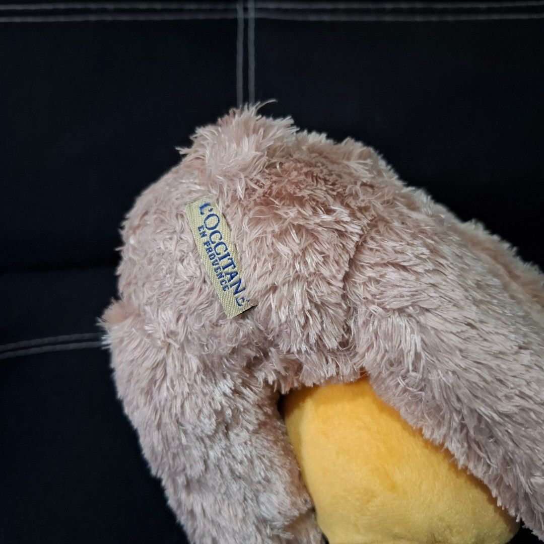 L'Occitane Teddy Bear Plush Toy (Category: Plushies & Soft Toys) located in Baliuag. Submitted by ahgashop. (Listing ID 1469470079, Image 3). Description: - Brand: L'Occitane - Item: Collectible plush teddy bear with yellow and brown honey pot - Details: Soft brown fur, yellow ribbon around the neck.