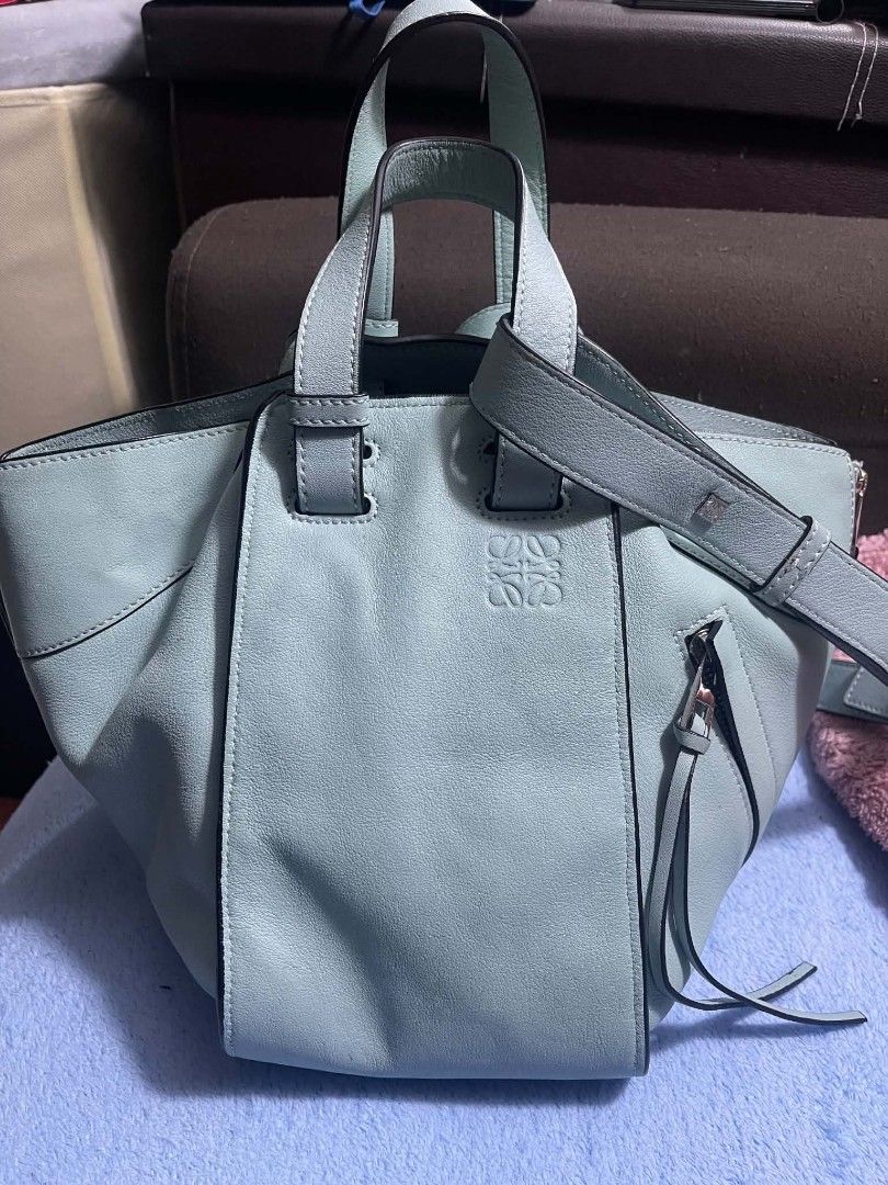 Loewe Hammock Small Smoke Blue 2-Way Handbag (Category: Shoulder Bags) located in Manila. Submitted by jjm-collections (Listing ID 1469400666, Image 2). Description: - Brand: Loewe - Style: Hammock Bag - Color: Smoke Blue - Material: Premium Leather - Dimensions: 9.8 x 12.2 x 5.3 inches - Versatility: Two-way design (shoulder bag or top handle tote) - Details: Side zip pocket with tassel pulls, debossed Anagram logo on front - Interior: Herringbo