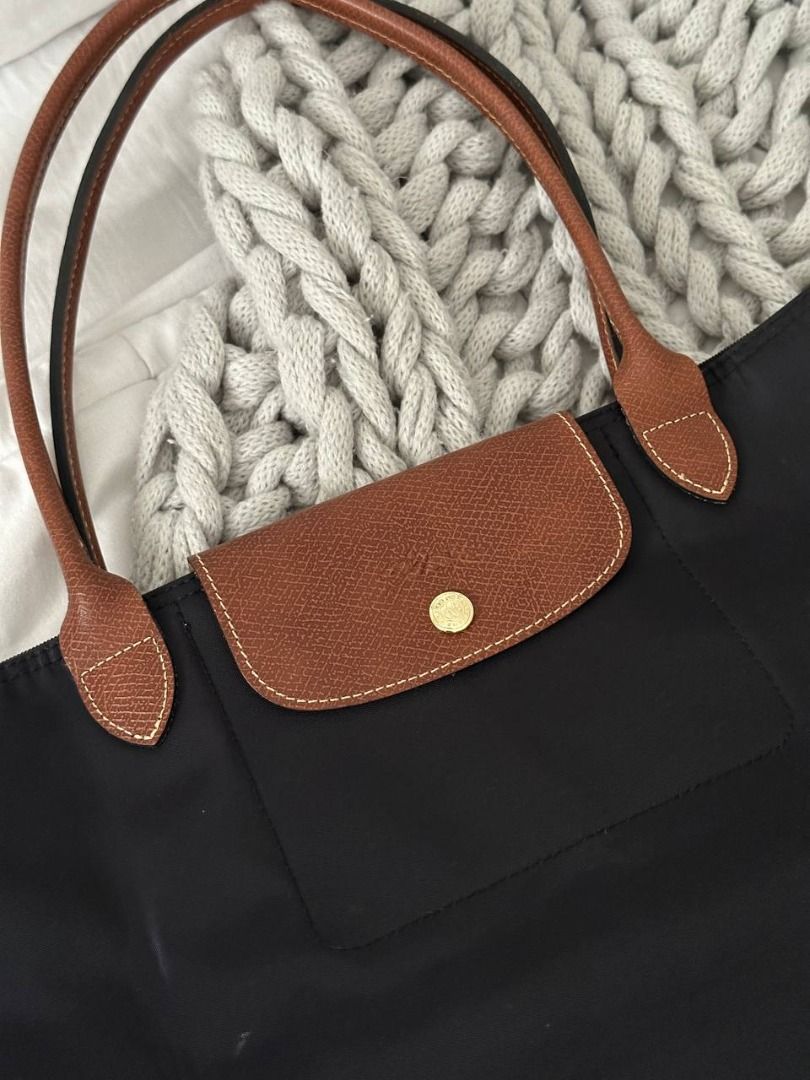 Longchamp Le Pliage Long Handle Tote Bag Black (Category: Luxury Bags & Wallets) located in Quezon City. Submitted by flipandfind (Listing ID 1469418478, Image 2). Description: - Longchamp Le Pliage Tote - Color: Classic Black nylon with rich brown leather handles and flap - Hardware: Gold-tone snap button and signature horse zipper pull - Closure: Top zip closure for added security - Interior: Spacious main compartment with a convenient small sl
