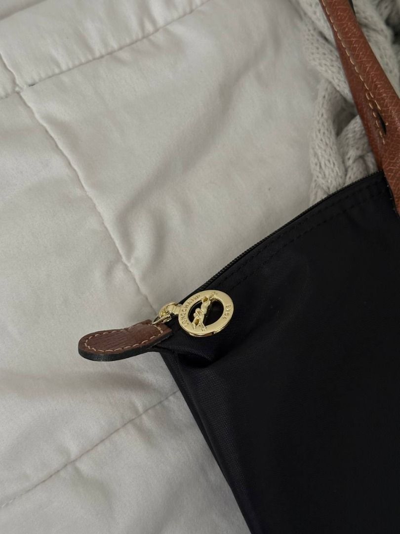 Longchamp Le Pliage Long Handle Tote Bag Black (Category: Luxury Bags & Wallets) located in Quezon City. Submitted by flipandfind (Listing ID 1469418478, Image 3). Description: - Longchamp Le Pliage Tote - Color: Classic Black nylon with rich brown leather handles and flap - Hardware: Gold-tone snap button and signature horse zipper pull - Closure: Top zip closure for added security - Interior: Spacious main compartment with a convenient small sl