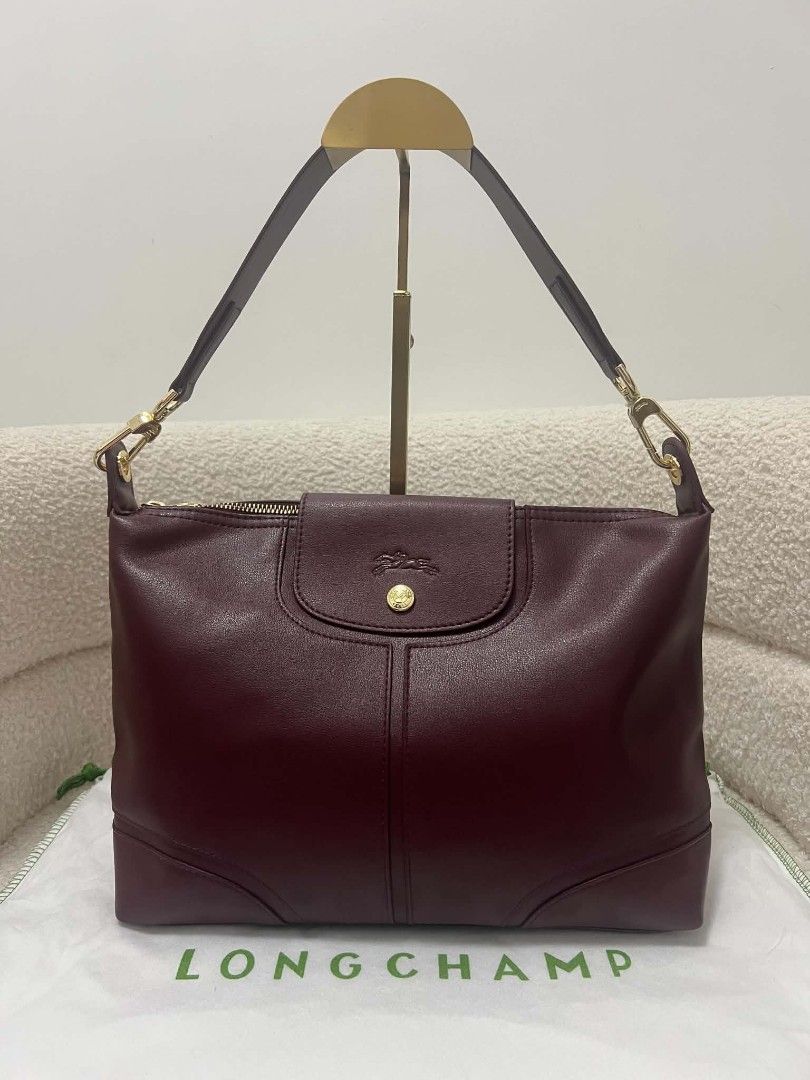 Longchamp Leather Shoulder Bag (Category: Shoulder Bags) located in Paoay. Submitted by rvf1230 (Listing ID 1469401930, Image 3). Description: - Brand: Longchamp - Color: Deep burgundy - Material: Premium leather with gold-tone hardware - Closure: Secure top zip closure - Exterior: Front flap pocket with iconic embossed horse logo - Strap: Single detachable shoulder strap - Interior: Clean interior with a structured base - Inclusion: Original dus