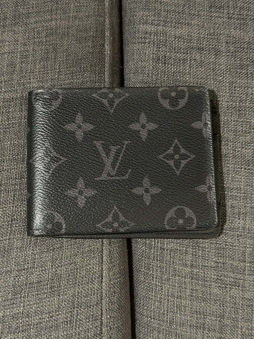 Louis Vuitton Multiple Wallet Monogram Eclipse (Category: Luxury Bags & Wallets) located in Manila. Submitted by mialuna_ (Listing ID 1469421754, Image 1). Description: - Authentic Louis Vuitton Multiple Wallet - Monogram Eclipse canvas in dark grey and black - Interior includes card slots, slip pockets, and a bill compartment - Features leather interior lining - Personalized with silver hot-stamped initials CG on the lower right - Clean shape wi