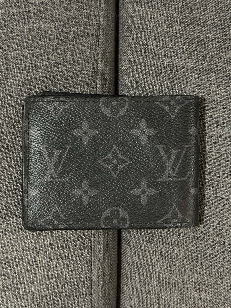 Louis Vuitton Multiple Wallet Monogram Eclipse (Category: Luxury Bags & Wallets) located in Manila. Submitted by mialuna_ (Listing ID 1469421754, Image 2). Description: - Authentic Louis Vuitton Multiple Wallet - Monogram Eclipse canvas in dark grey and black - Interior includes card slots, slip pockets, and a bill compartment - Features leather interior lining - Personalized with silver hot-stamped initials CG on the lower right - Clean shape wi