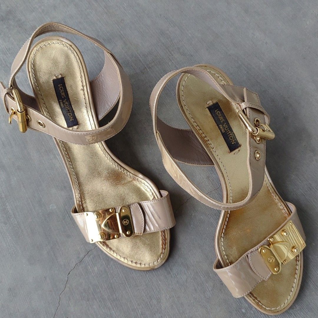 LOUIS VUITTON WEDGE SANDALS (Category: Wedges) located in Barotac Nuevo. Submitted by yorcollections (Listing ID 1469468535, Image 2). Description: LOUIS VUITTON WEDGE SANDALS Louis Vuitton ankle-belt patent leather wedge sandals in a metallic gold and beige tone, gold-tone lock hardware details on the front strap and ankle closure Size 37 on tag.