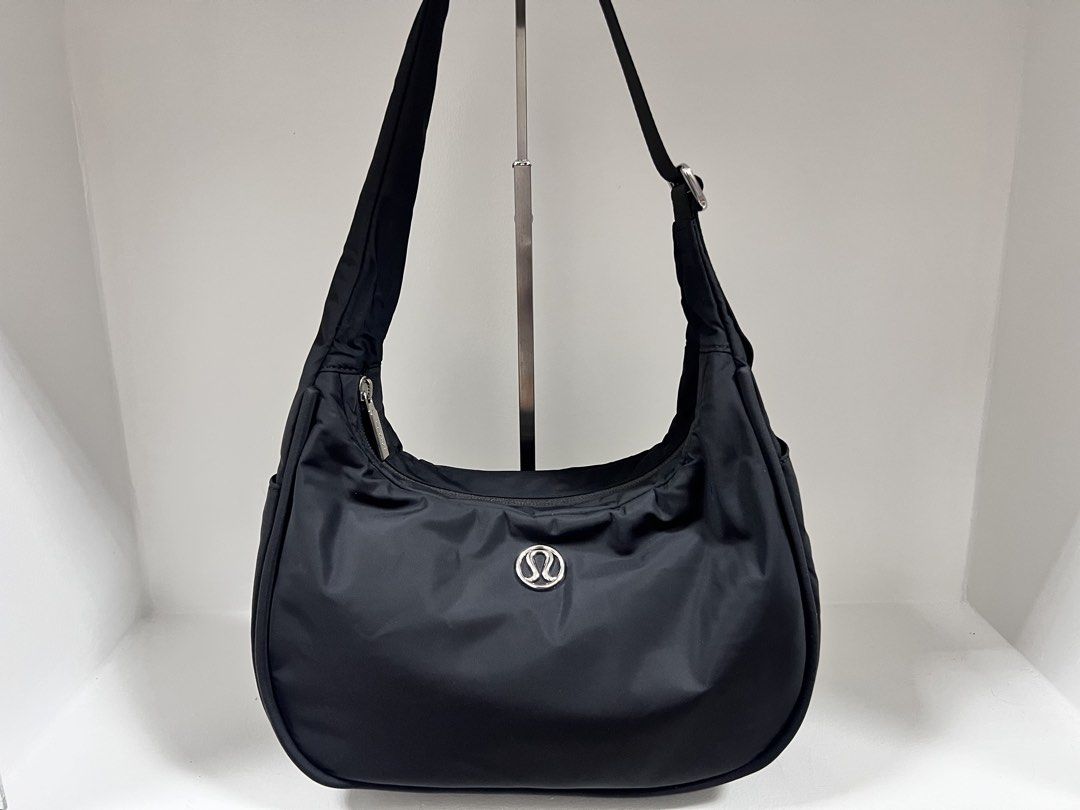 Lululemon City Essentials Shoulder Bag 4L (Category: Cross-body Bags) located in San Jose del Monte. Submitted by itstokyotokyo (Listing ID 1469394002, Image 1). Description: Authenthic💯 / Used Twice / 9.5:10 / As Is Where Is✨ - Brand: Lululemon - Color: Classic Black - Material: Clean, lightweight nylon with silver-tone hardware - Design: Practical crescent shape with front logo emblem - Storage: Main zip compartment + exterior zippered pocket 