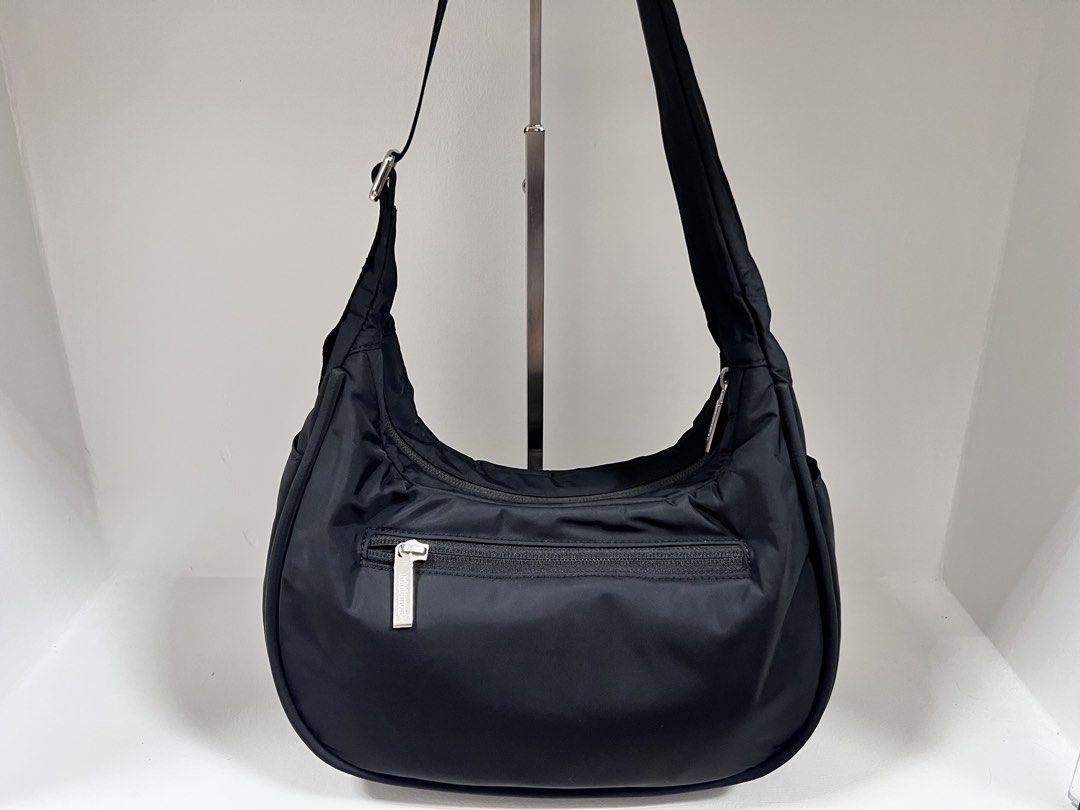 Lululemon City Essentials Shoulder Bag 4L (Category: Cross-body Bags) located in San Jose del Monte. Submitted by itstokyotokyo (Listing ID 1469394002, Image 2). Description: Authenthic💯 / Used Twice / 9.5:10 / As Is Where Is✨ - Brand: Lululemon - Color: Classic Black - Material: Clean, lightweight nylon with silver-tone hardware - Design: Practical crescent shape with front logo emblem - Storage: Main zip compartment + exterior zippered pocket 