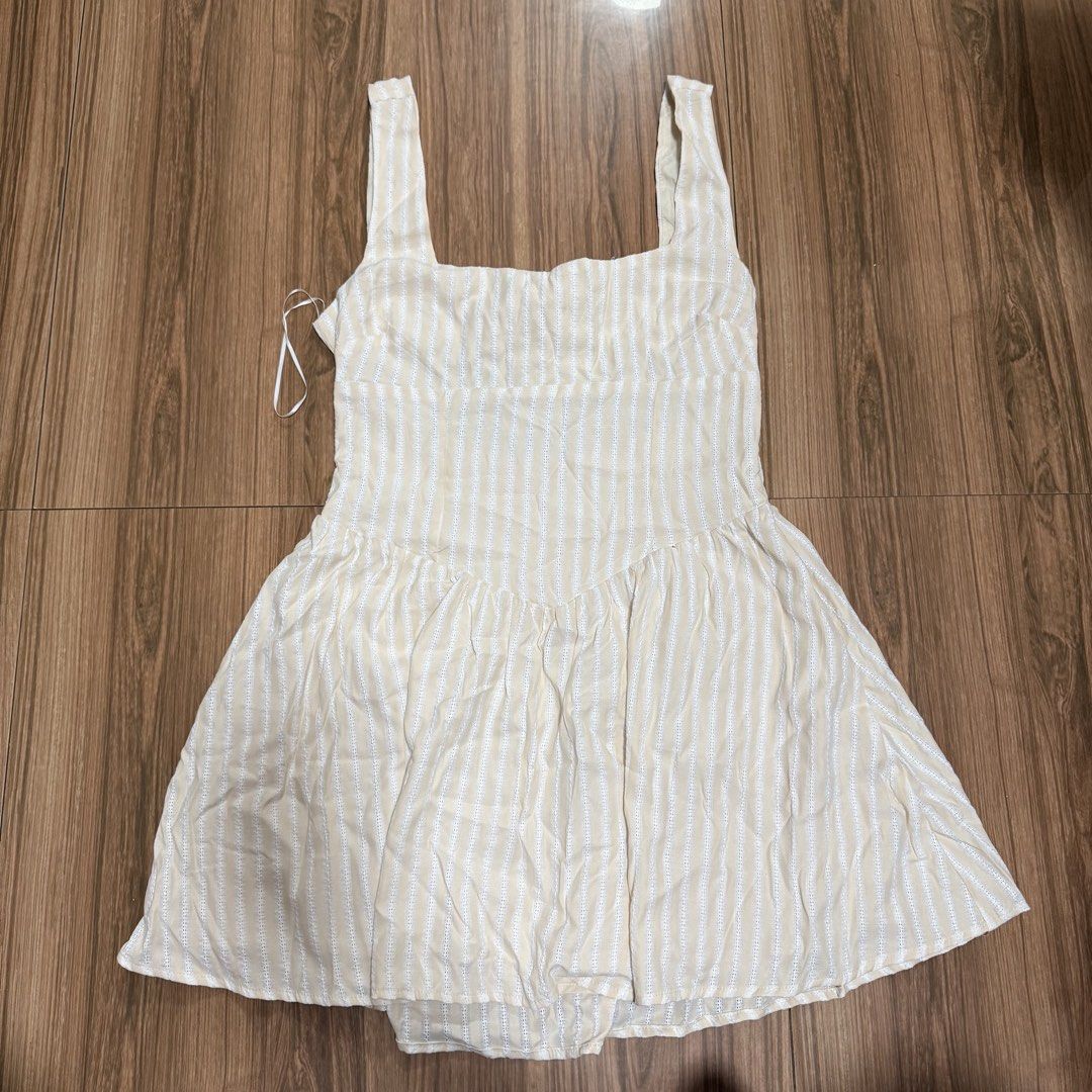 Luvalot Beige Stripe Mini Dress (Category: Dresses) located in Binangonan. Submitted by curatedbyjuys (Listing ID 1469441788, Image 1). Description: - Brand: Luvalot - Condition: Brand new with tags (BNWT) - Color/Pattern: Beige and white stripes - Design: Square neckline with thick straps - Back Detail: Open back with adjustable string ties - Fit: Flared skater skirt style.