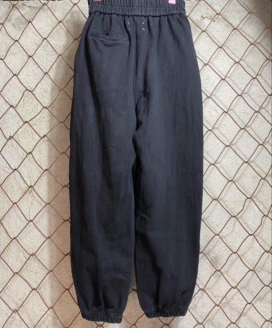Maison Margiela Black Sweatpants Size 40 (Category: Joggers) located in Cabanatuan. Submitted by adrialesdrip (Listing ID 1469500180, Image 1). Description: - Brand: Maison Margiela - Color: Black with a stylish washed look - Size: 40 - Material: Comfortable, premium cotton - Fit: Casual fit with elastic waistband and matching ankle cuffs - Details: Features the iconic four white stitches on the back and a convenient single rear pocket on the rig