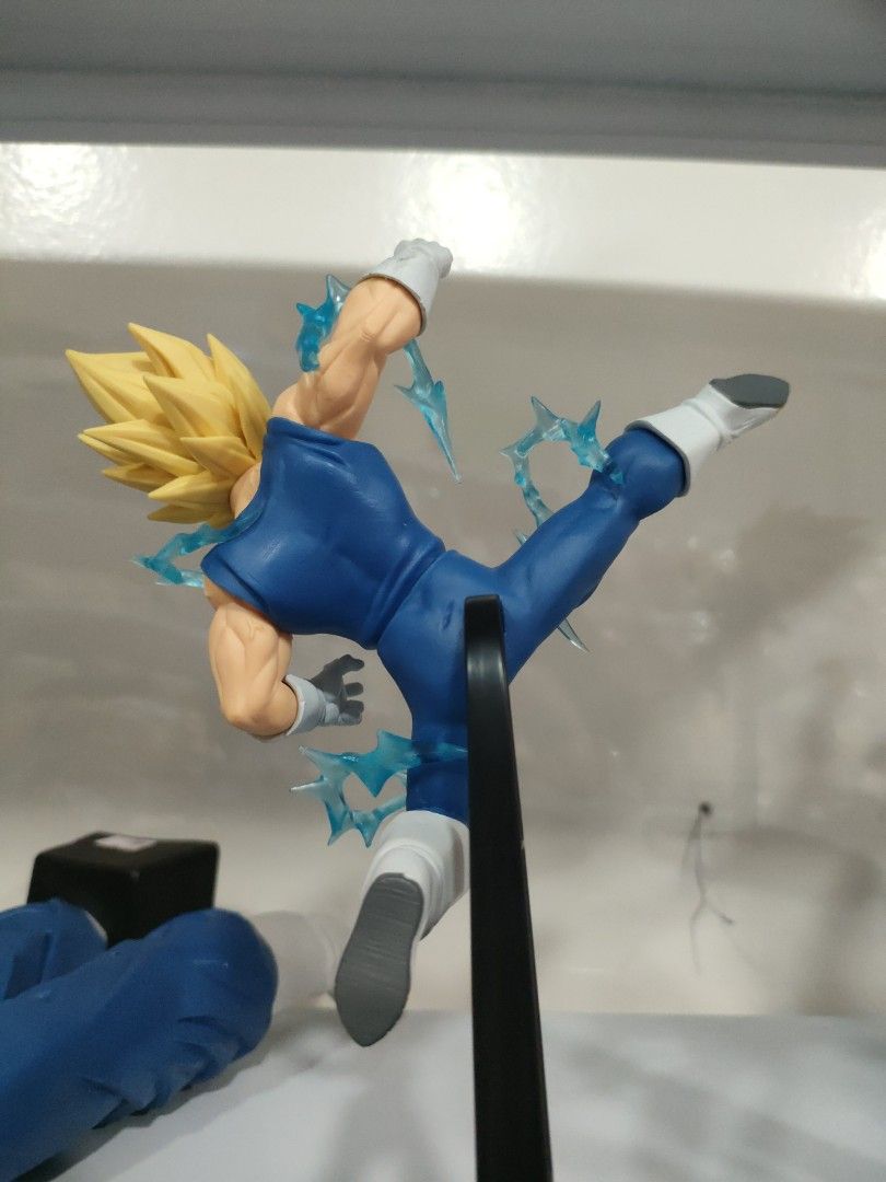 Majin Vegeta figure (Category: Figurines & Statues) located in Bulacan. Submitted by hunterherojapanjdm (Listing ID 1469474574, Image 2). Description: Banpresto Dragon Ball Z Match Makers Majin Vegeta figure, which captures him in a dynamic mid-air kick pose with translucent blue energy effects as he faces off against Super Saiyan 2 Son Goku..