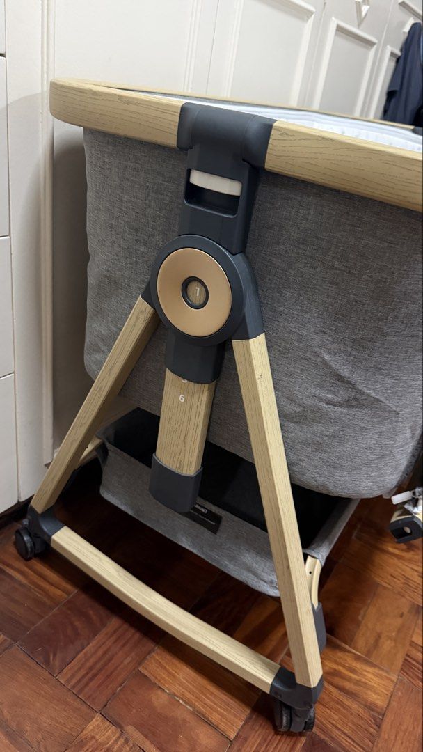 Mambo Baby Bedside Cot with Mosquito Net (Category: Cots & Cribs) located in Santa Cruz. Submitted by jlchua (Listing ID 1469509862, Image 3). Description: - Stylish grey Mambo bedside crib with chic wood-grain finish legs - Breathable mesh sides for optimal airflow and easy baby monitoring - Adjustable height levels to fit most beds securely - Includes a cozy mattress with a cute star-patterned lining - Detachable mosquito net canopy for added p