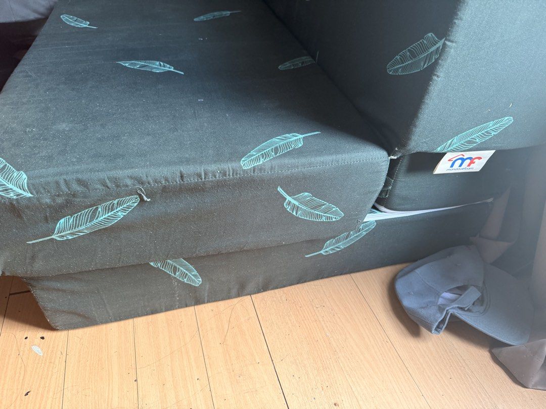 Mandaue Foam Foldable Sofa Bed with Feather Print (Category: Sofas) located in Manila. Submitted by andross09 (Listing ID 1469398392, Image 2). Description: - Brand: Mandaue Foam - Design: Dark grey fabric with light blue feather pattern - Function: Easily converts from a folded sofa to a flat mattress - Maintenance: Removable zippered cover for easy washing - Ideal For: Small apartments, living rooms, or guest rooms - Condition: Clean fabric ove