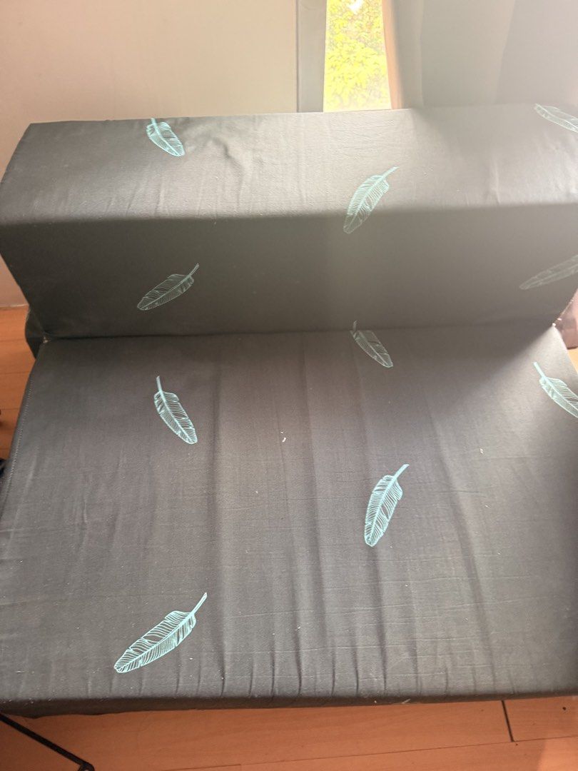 Mandaue Foam Foldable Sofa Bed with Feather Print (Category: Sofas) located in Manila. Submitted by andross09 (Listing ID 1469398392, Image 1). Description: - Brand: Mandaue Foam - Design: Dark grey fabric with light blue feather pattern - Function: Easily converts from a folded sofa to a flat mattress - Maintenance: Removable zippered cover for easy washing - Ideal For: Small apartments, living rooms, or guest rooms - Condition: Clean fabric ove