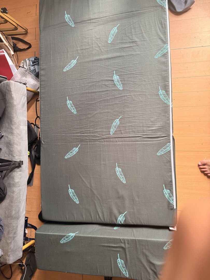 Mandaue Foam Foldable Sofa Bed with Feather Print (Category: Sofas) located in Manila. Submitted by andross09 (Listing ID 1469398392, Image 3). Description: - Brand: Mandaue Foam - Design: Dark grey fabric with light blue feather pattern - Function: Easily converts from a folded sofa to a flat mattress - Maintenance: Removable zippered cover for easy washing - Ideal For: Small apartments, living rooms, or guest rooms - Condition: Clean fabric ove