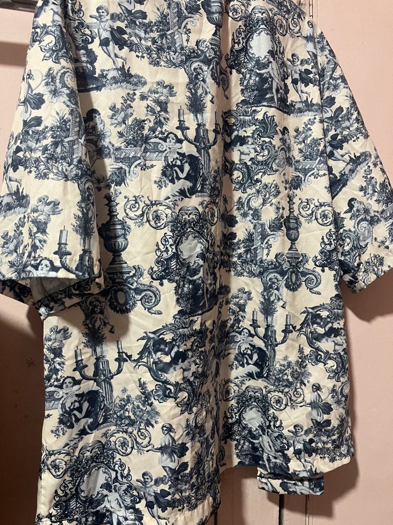 Manfinity Blue White Baroque Print Button Down Shirt Size S (Category: Formal Shirts) located in Manila. Submitted by pinkmowchiiii (Listing ID 1469537375, Image 3). Description: Manfinity short sleeve button down shirt. Size S, fits true to size. Cream base with blue and black baroque style toile print depicting cherubs, urns, and scrolling patterns. Camp collar neckline, regular fit, lightweight fabric. Great statement piece for summer or casua