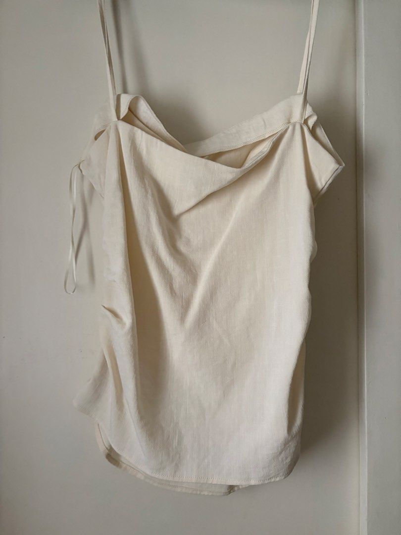 Mango Cream Camisole Top Size M (Category: Sleeveless) located in Pasig City. Submitted by makeuplover219 (Listing ID 1469437022, Image 2). Description: - Brand: MNG Mango - Size: Medium (M) - Color: Cream - Design: low neckline with thin spaghetti straps and ruched side detail - Versatile piece, easy to dress up or down - SF: c/o buyer Grab, Gogo Express, and Lalamove.