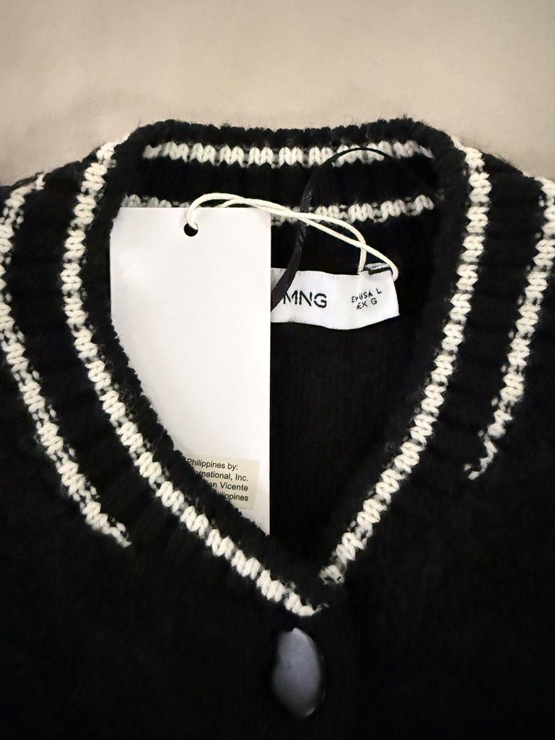 Mango Knitted Bomber Jacket Black Size L (Category: Coats, Jackets and Outerwear) located in Caloocan City. Submitted by triciadrilvs (Listing ID 1469441081, Image 3). Description: - Brand: Mango - Item: Knitted Bomber Jacket - Color: Black with contrast white striped ribbed trim (collar, cuffs, hem, and pockets) - Closure: Snap button front - Pockets: Two functional front pockets - Size: L - Condition: Brand new with original store tags attached