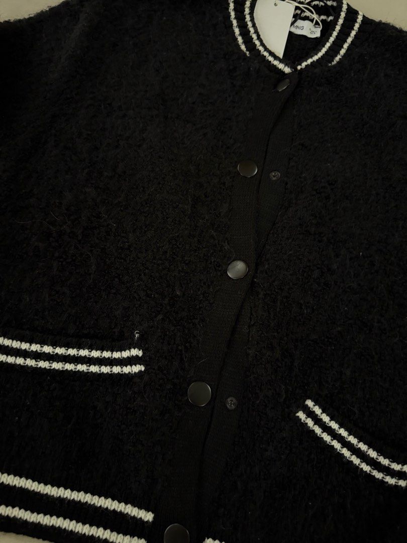 Mango Knitted Bomber Jacket Black Size L (Category: Coats, Jackets and Outerwear) located in Caloocan City. Submitted by triciadrilvs (Listing ID 1469441081, Image 2). Description: - Brand: Mango - Item: Knitted Bomber Jacket - Color: Black with contrast white striped ribbed trim (collar, cuffs, hem, and pockets) - Closure: Snap button front - Pockets: Two functional front pockets - Size: L - Condition: Brand new with original store tags attached