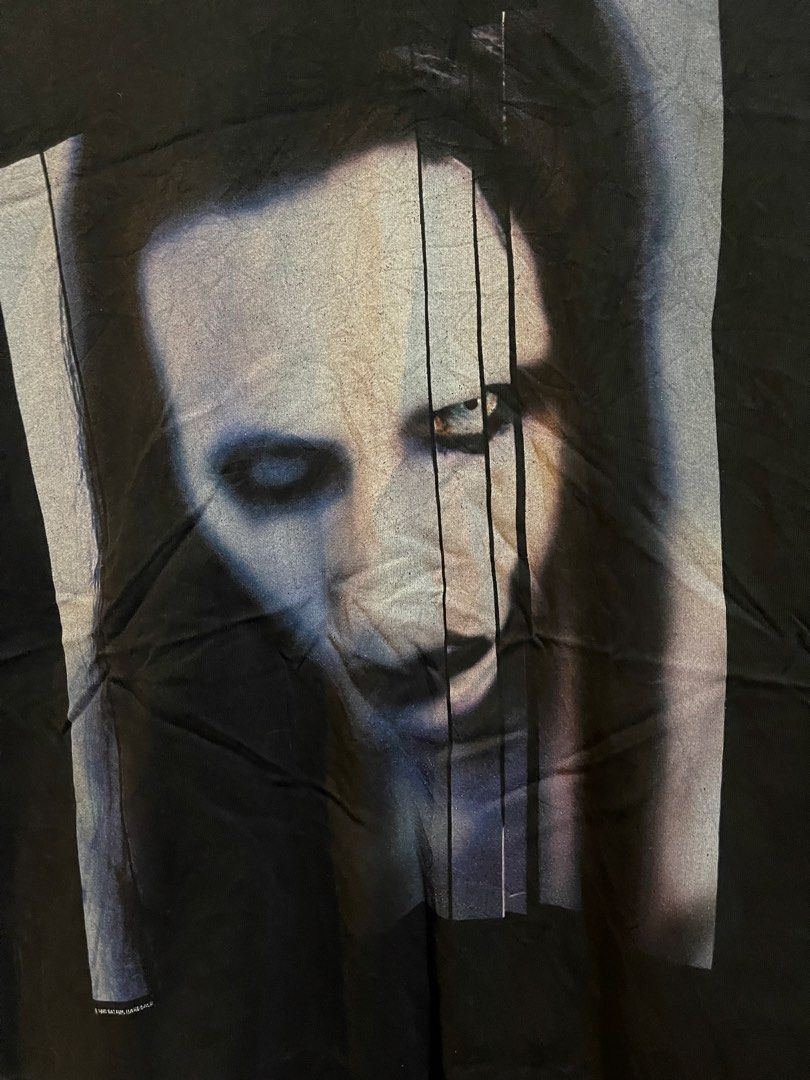 Marilyn Manson Tshirt (Category: Tshirts & Polo Shirts ) located in Manila. Submitted by brex_3108 (Listing ID 1469441026, Image 2). Description: 🔥 Cool vintage-inspired graphic print! ✔️ Brand: Winterland ✔️ Color: Black ✔️ Material: 100% Cotton ✔️ Width: 21 inches ✔️ Length: 29.5 inches ✔️ Unique graphic design ✔️ Perfect for casual and streetwear outfits 📏 Measurements: • Pit-to-pit width: 21” • Length: 29.5” 💯 Pre-loved item. Please see ac