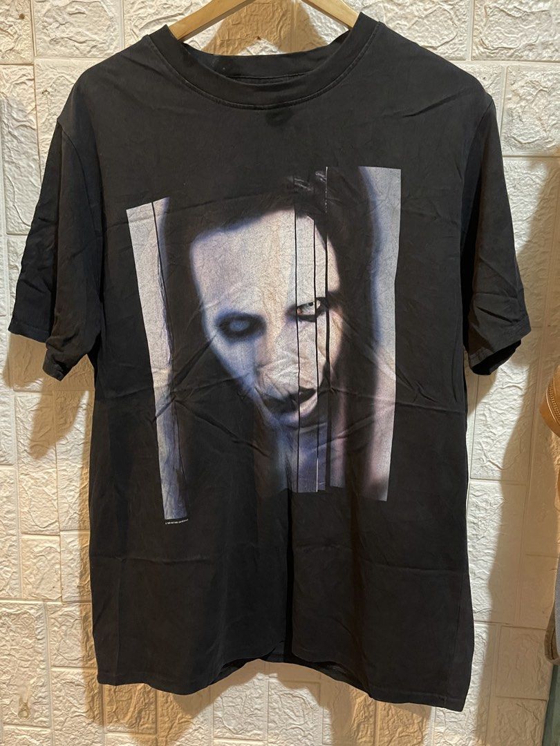 Marilyn Manson Tshirt (Category: Tshirts & Polo Shirts ) located in Manila. Submitted by brex_3108 (Listing ID 1469441026, Image 1). Description: 🔥 Cool vintage-inspired graphic print! ✔️ Brand: Winterland ✔️ Color: Black ✔️ Material: 100% Cotton ✔️ Width: 21 inches ✔️ Length: 29.5 inches ✔️ Unique graphic design ✔️ Perfect for casual and streetwear outfits 📏 Measurements: • Pit-to-pit width: 21” • Length: 29.5” 💯 Pre-loved item. Please see ac