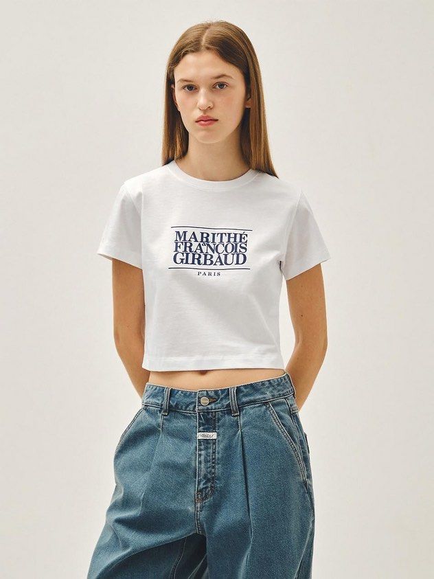Marithe Francois Girbaud White Logo T-shirt (Category: Shirts) located in Mandaue City. Submitted by chinsyap_03 (Listing ID 1469465847, Image 2). Description: - Brand: Marithé François Girbaud - Color: Clean bright white - Design: Classic block lettering with Paris address detail - Fit: Cropped, boxy fit with short sleeves and crew neck - Size: Tagged S (fits S-M nicely) - Styling: Perfect with baggy denim or cargo pants.