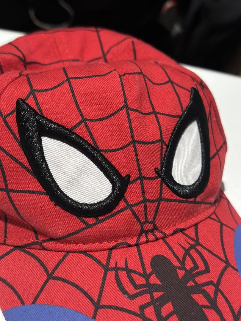 Marvel Spider-Man Youth Size Cap (Category: Caps & Hats) located in Daet. Submitted by thrifthings2018 (Listing ID 1469481158, Image 3). Description: - Official Marvel Spider-Man youth cap - Vibrant red fabric with black web print and blue accent panels - White embroidered eye details and cool spider graphic on the brim - Authentic interior Marvel branding tag - Clean overall shape, perfect for young fans.