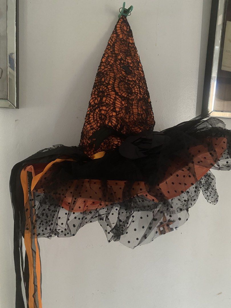 Masq by Blueoco Orange and Black Witch Hat (Category: Hats & Beanies) located in Manila. Submitted by jossarisar23239 (Listing ID 1469453284, Image 1). Description: - Brand: Masq (Model MAS74962-OR) - Design: Orange witch hat with black lace overlay and polka dot mesh tulle brim - Features: Long dangling ribbons on the side - Condition: Brand new with original store tag attached - Perfect for: Halloween parties, dress-up, and costume events.