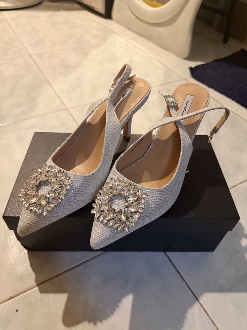Matthews Adrienne Silver Sparkle Slingback Heels Size 39 (Category: Heels) located in Manila. Submitted by reginemariev (Listing ID 1469441455, Image 1). Description: -I am size 38 and one size higher. - Brand/Model: Matthews Adrienne - Size: EU 39 - Color/Finish: Silver with all-over glitter - Details: Eye-catching large crystal buckle on a sleek pointed toe - Heel: Medium stiletto - Closure: Adjustable ankle strap with small buckle - Inclusion: