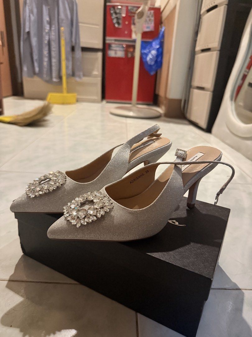 Matthews Adrienne Silver Sparkle Slingback Heels Size 39 (Category: Heels) located in Manila. Submitted by reginemariev (Listing ID 1469441455, Image 2). Description: -I am size 38 and one size higher. - Brand/Model: Matthews Adrienne - Size: EU 39 - Color/Finish: Silver with all-over glitter - Details: Eye-catching large crystal buckle on a sleek pointed toe - Heel: Medium stiletto - Closure: Adjustable ankle strap with small buckle - Inclusion: