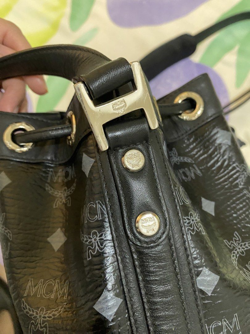 MCM Black Monogram Leather Bucket Bag (Category: Luxury Bags & Wallets) located in Paranaque City. Submitted by chelleann12 (Listing ID 1469442629, Image 3). Description: - Brand: MCM - Style: Bucket bag with drawstring closure - Material/Design: Classic black monogram print with silver-tone hardware and metal logo plate - Serial Number: W8798 - Strap: Adjustable shoulder strap with metal rings - Interior: Clean fabric lining with a spacious main