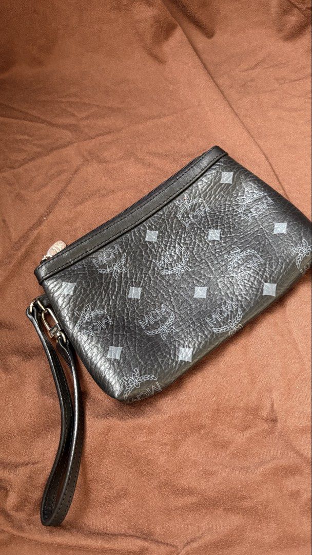 MCM Black Monogram Leather Wristlet Clutch (Category: Luxury Bags & Wallets) located in Taguig. Submitted by awatc_hes (Listing ID 1469446684, Image 1). Description: - Authentic Black MCM monogram leather wristlet - Secure zip-top closure with sleek silver-tone hardware - Versatile design with a removable wrist strap - Clean interior lining featuring a spacious open main compartment - Compact and lightweight, perfect for carrying your daily essen