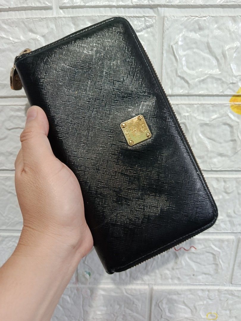 MCM Black Zipped Long Wallet (Category: Luxury Bags & Wallets) located in Cagayan de Oro. Submitted by pastel829 (Listing ID 1469448308, Image 1). Description: - Brand: MCM - Material: Textured Saffiano leather - Color: Black with gold-tone hardware - Closure: Secure zip-around - Exterior: Iconic MCM München metal plaque - Interior: Multiple card slots, slip compartments, and zippered coin pocket - Lining: MCM jacquard fabric - Condition: Clean i