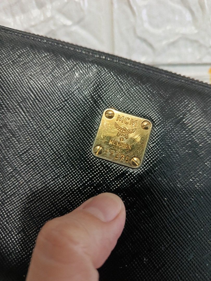 MCM Black Zipped Long Wallet (Category: Luxury Bags & Wallets) located in Cagayan de Oro. Submitted by pastel829 (Listing ID 1469448308, Image 2). Description: - Brand: MCM - Material: Textured Saffiano leather - Color: Black with gold-tone hardware - Closure: Secure zip-around - Exterior: Iconic MCM München metal plaque - Interior: Multiple card slots, slip compartments, and zippered coin pocket - Lining: MCM jacquard fabric - Condition: Clean i