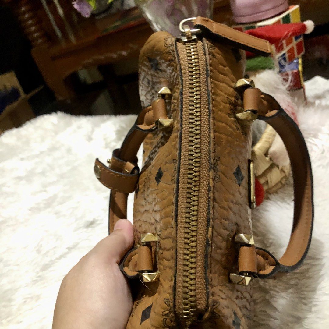 MCM Monogram Boston Bag (Category: Luxury Bags & Wallets) located in Meycauayan. Submitted by miletteaqu82717 (Listing ID 1469415574, Image 3). Description: - Brand: MCM - Style: Boston Bag - Color/Pattern: Classic Brown Monogram - Hardware: Gold-tone with front metal plaque - Straps: Dual top handles & detachable shoulder strap - Closure: Top zipper - Interior: Fabric-lined with 1 slip pocket - Mode of Payment: thru GCash.